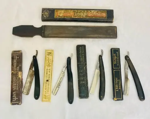Collection of 5 antiques 1900-20’s Barber razors and leather sharpener with original boxes!